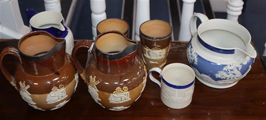 Two Doulton Lambeth jugs and two beakers with silver mounted rings and three white stoneware vessels, possibly Turner of Lane End